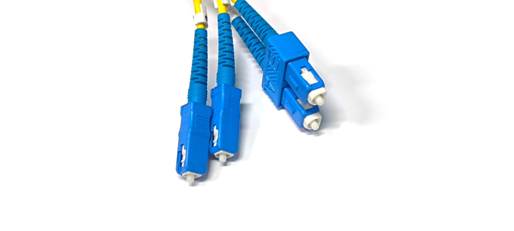 blue fiber optic cable with blue cable and yellow cable on a white background.